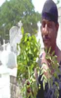 With his blessing and cleansing done Armando Kneels before the modest  Marie Laveau, Glapion tomb to pray for a special client. He prays aloud, and ask Chicken Man's spirit to send a special blessing also...