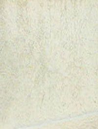 Several Distinct faces on the side of the tomb.