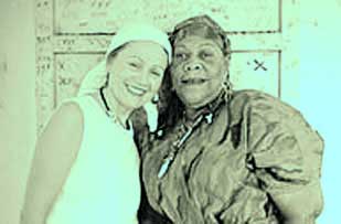 Ina Fandrich, left, visits Marie Laveau's grave in New Orleans with Mama Lola, a voodoo priestess from Haiti who has lived in Brooklyn, N.Y.