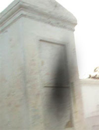 A Shadow figure before the tomb of the Glapion family burial spot of Marie Laveau, Phot from Georgie Lester.
