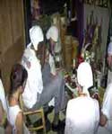 A large group of white-clad Voudo participants showed up this night and we all came together in Mambo Sallie Ann’s temple to participate and be washed by Papa.